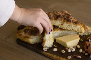 Canvas Print - View of a wooden board Focaccia, ham cheese, wine and pistachio