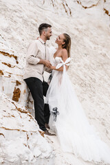 Wall Mural - Beautiful wedding couple bride and groom at wedding day outdoors at ocean beach. Happy marriage couple o