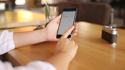 Wall Mural - female sets up fingerprint on her smartphone for secure login and privacy. woman unlocks mobile phon