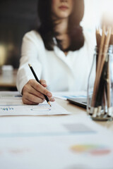 focus woman holding a pencil Auditors use budget document calculators to find annual budget disbursement errors.