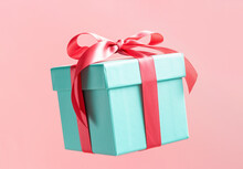 Blue Gift Box With Ribbon On Pink Background Close-up.