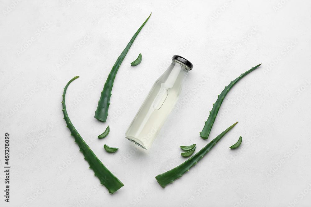 Bottle of healthy aloe juice on white background