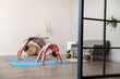 © Pixel-Shot - Little girl with her mother practicing yoga at home