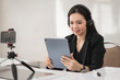 © EduLife Photos - Adult Asian female college teacher teaching online via video conference meeting to students at home. Smiling Asian female tutor having a video call with students