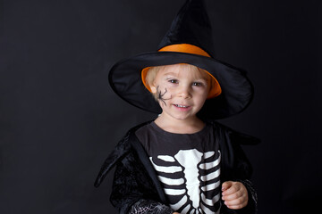 Poster - Child, dressed for Halloween, playing at home, isolated image on black