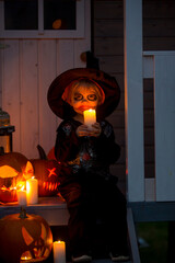 Canvas Print - Scary toddler child in halloween costume, playing with carved pumpkins