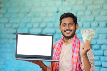 Sticker - Young indian farmer showing laptop screen and money