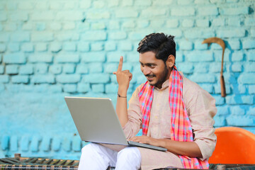 Wall Mural - Technology concept : Indian farmer using laptop at home