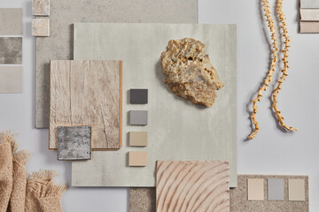 Flat lay of creative architect moodboard composition with samples of building, textile and natural materials and personal accessories. Top view, grey background, template.