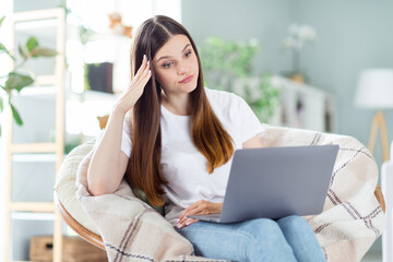 Sticker - Portrait of attractive frustrated girl sitting in chair using laptop watching boring video at home light living room indoors