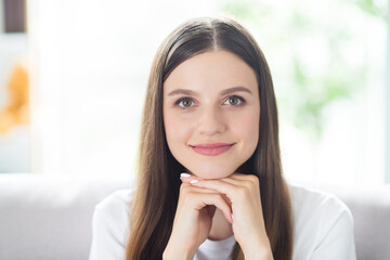 Sticker - Portrait of attractive cheerful peaceful brown-haired girl sitting on divan resting free time at home indoors