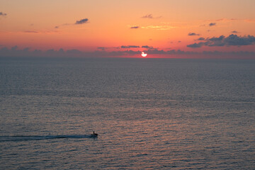 Wall Mural - calm water at dawn. the first rays of the sun illuminate the clouds reflecting in the calm water at dawn