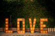© ADDICTIVE STOCK - Illuminated love word in garden