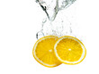 two orange slices fall under the water with a splash