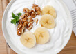 Yogurt breakfast with banana and walnuts