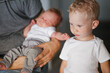 © Cavan Images - older brother with younger brother in father's arms