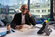 © Cavan Images - Black businesswoman answering phone call