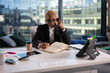 © Cavan Images - African American businesswoman making notes during phone call