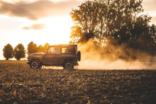 A Jeep Drives Offroad In A Field