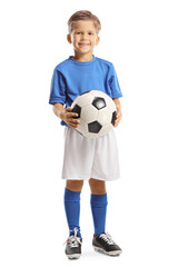 Cute little boy holding a soccer ball and smiling at camera