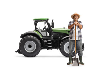 Sticker - Full length portrait of a mature farmer posing with a shovel in front of a tractor