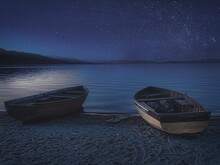 Boat Moored On Beach Against Sky At Night