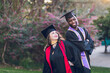 © Cavan - Young man & woman graduating college, wearing a graduation gown/cap.