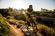 Mountain Biker At Sunrise With Richmond Skyline In The Background.