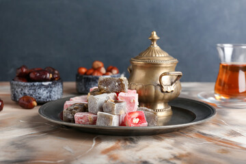 Tray with sweet Turkish delight on table