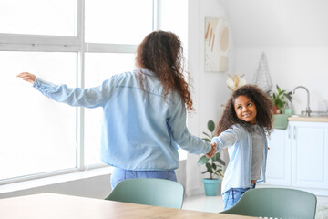 Canvas Print - African-American little girl dancing with her mother at home