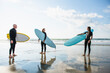© Cavan Images - Group of surfer friends during a summer sunrise surf