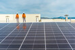 © Cavan Images - Unrecognizable solar panel technicians looking an installation Spain