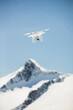 © Cavan Images - Drone flies in mid-air above a mountain summit, British Columbia.