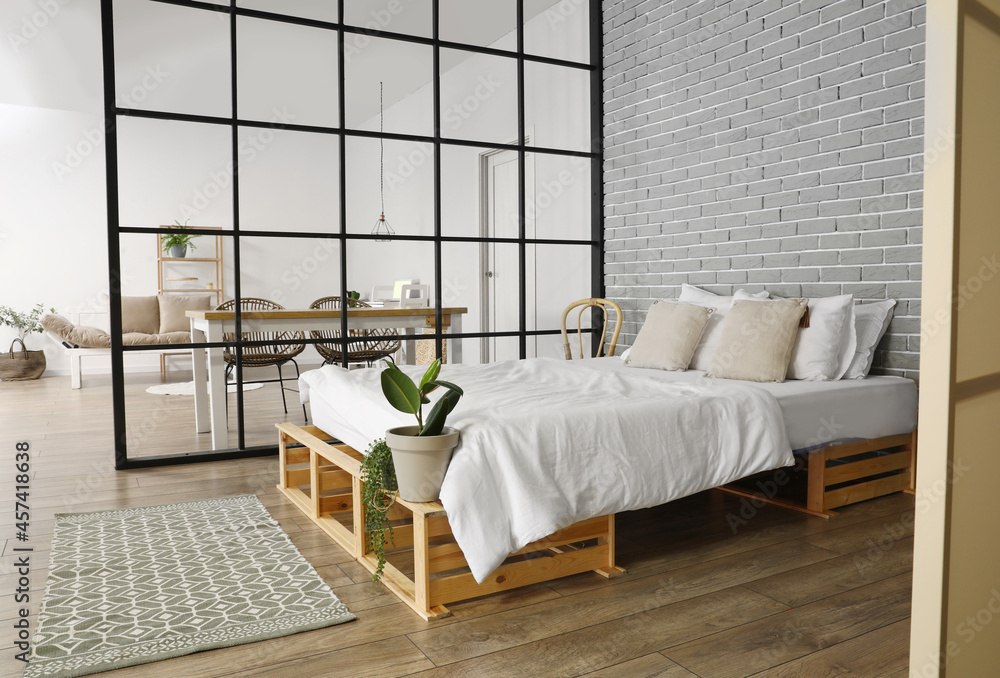 Interior of stylish bedroom with folding screen