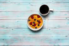 Bowl Of Cereal With Blueberries And Raspberries With Coffee On Wood