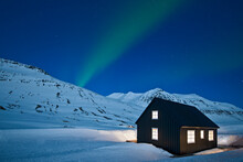 Aurora Borealis Over Remote Ski Cottage In Iceland On A Clear Night
