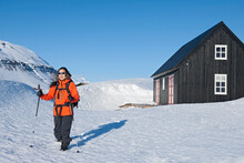 Woman Setting Off For A Hike From Ski Cottage In Iceland