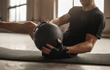 Man Doing Abs Exercise With Medicine Ball