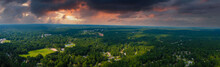 A Stunning Aerial Panoramic Shot Of Vast Miles Of Lush Green Trees With Powerful Clouds In The Sky With Homes Nestled Into The Trees At Huddleston Pond Park In Peachtree City, Georgia