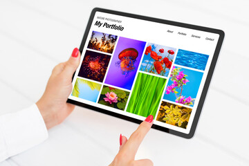 Wall Mural - Person viewing nature photography portfolio website on tablet
