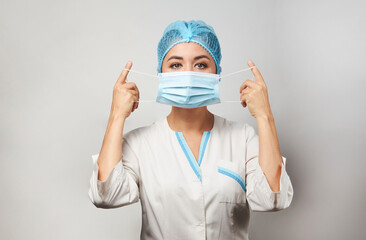 Wall Mural - Doctor wearing medical mask, close-up portrait