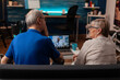 © DC Studio - Older people using video call conference on laptop with dentist while sitting on living room sofa. Senior man with tooth ache doing dental consultation on online remote communication.