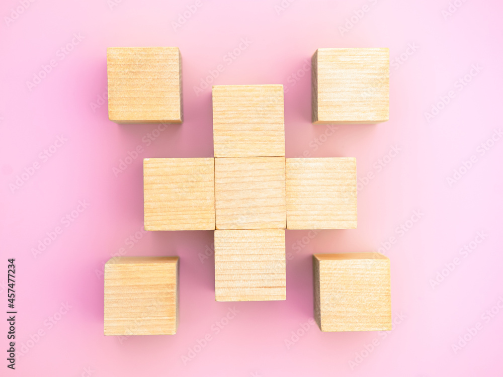 9 Block Sign Nine wooden blocks in the form of the plus on the pink background with ...