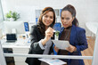 © DragonImages - Businesswoman drawing chart on glass wall to explain colleague her idea of company development