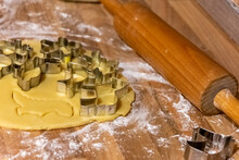 Fancy shaped cookie cutters on rolled fresh pastry