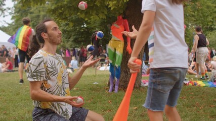 Dexterity training male teacher shows his skills in the camp. Juggling can help keep physically fit and mentally alert, improves eye-hand coordination. 