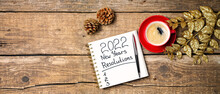 New Year Resolutions 2022 On Desk. 2022 Resolutions With Notebook, Christmas Ornaments On Wooden Background. Goals, Plan, List, Idea Concept. New Year 2022 Template With Copy Space