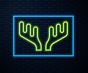 Wall Mural - Glowing neon line Deer antlers icon isolated on brick wall background. Hunting trophy on wall. Vector