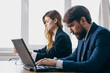 © SHOTPRIME STUDIO - business man and woman sitting in front of a laptop teamwork internet officials