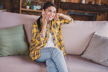 Poster - Photo of positive pretty person sit on couch speak telephone toothy smile have good mood enjoy weekend indoors